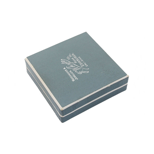 Blue jewellery box with white text on a white background