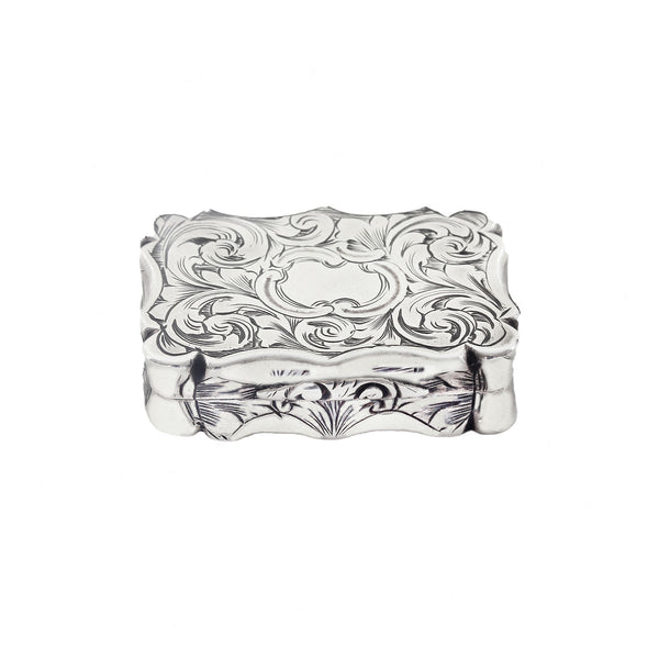 Decorative silver box with intricate patterns on a white background