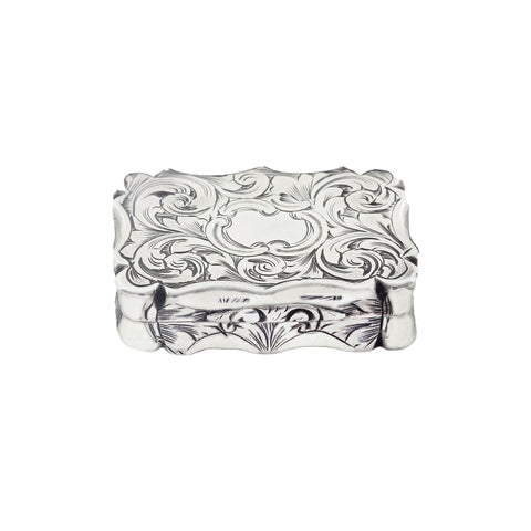 Decorative silver box with intricate patterns on a white background