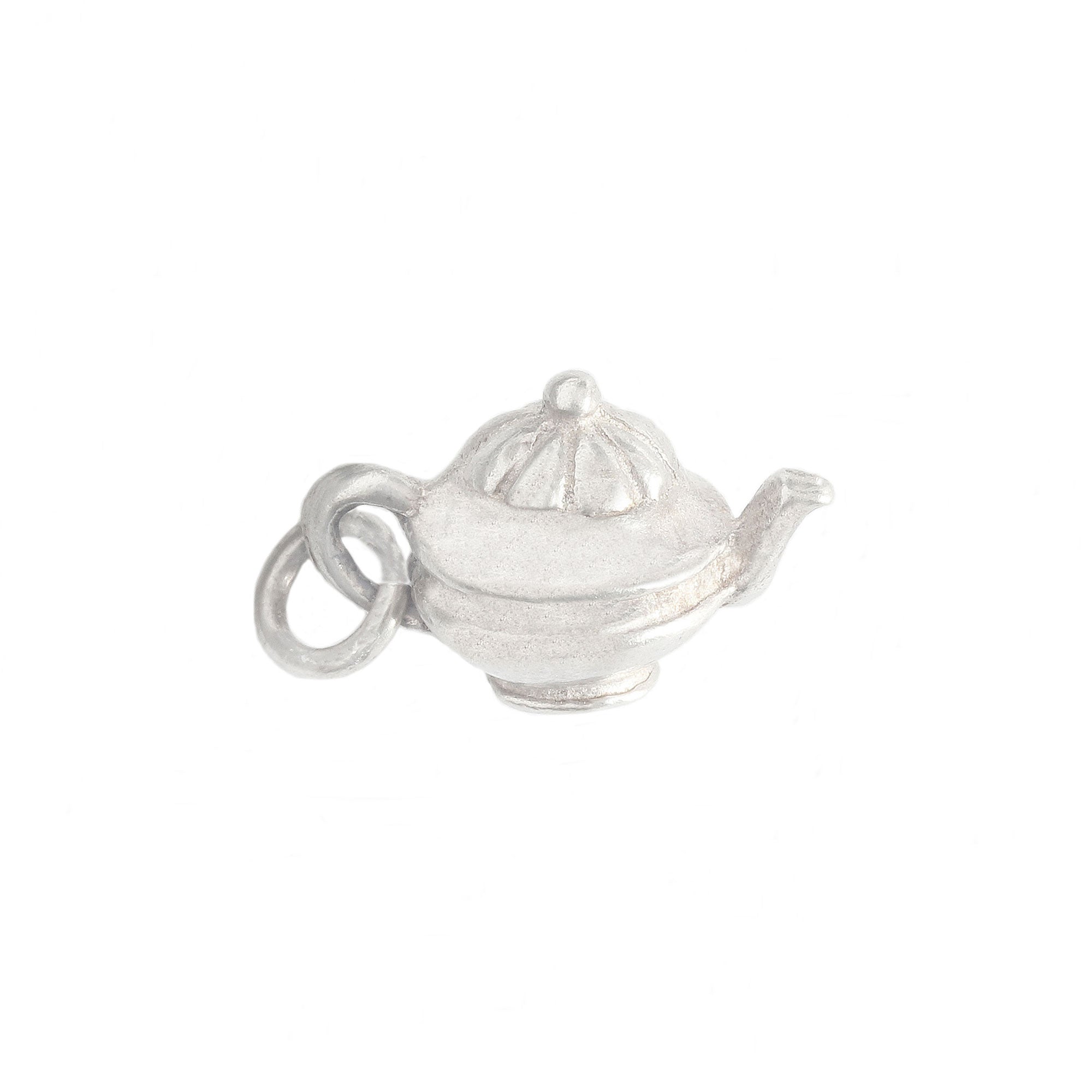 Silver teapot charm on a white background