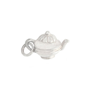 Silver teapot charm on a white background