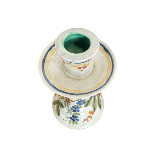 Ceramic candle holder with floral design on a white background