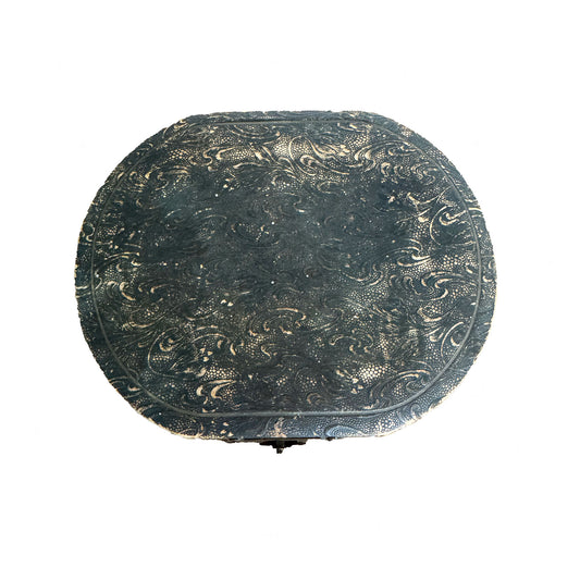 Decorative round object with intricate patterns on a white background