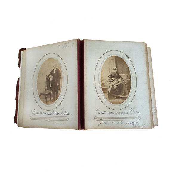 Open photo album with victorian portraits on a white background