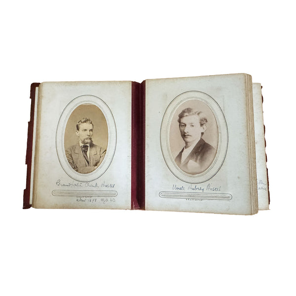 Open album with vintage portraits on a white background