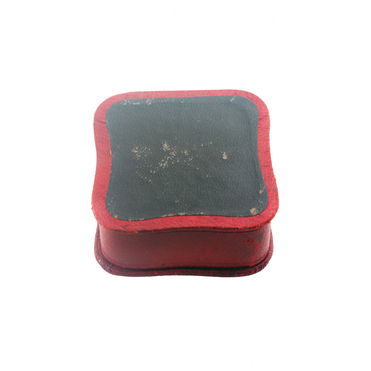 Small rectangular object with red border and grey centre on a white background