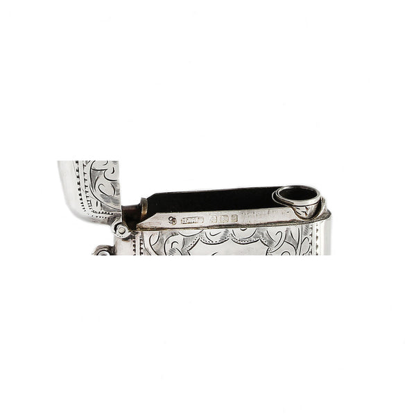 Silver  hallmark on vesta with intricate designs on a white background