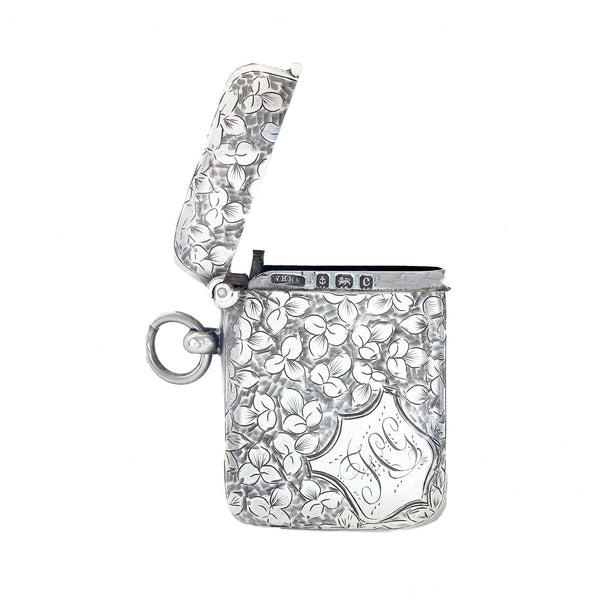Silver vesta with floral engraving on a white background