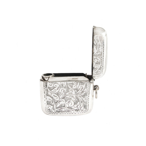 Silver vesta case with intricate designs on a white background