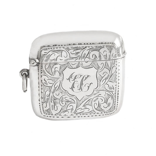Silver engraved case with initials on a white background