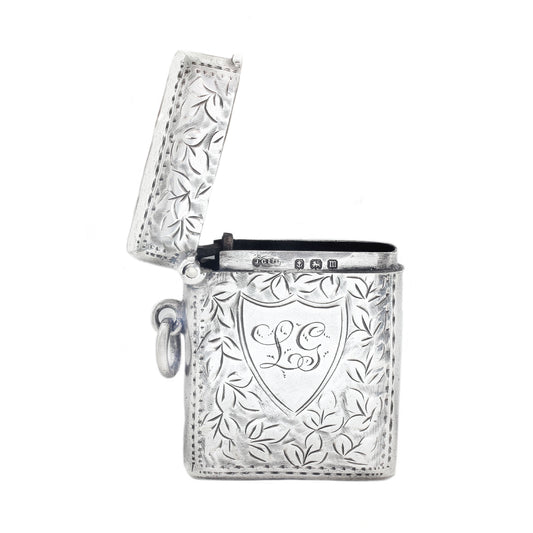 Decorative vesta with floral patterns and a central emblem on a white background