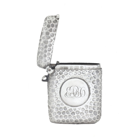 Silver textured vesta with monogram on a white background