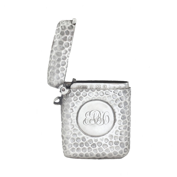 Silver textured vesta with monogram on a white background