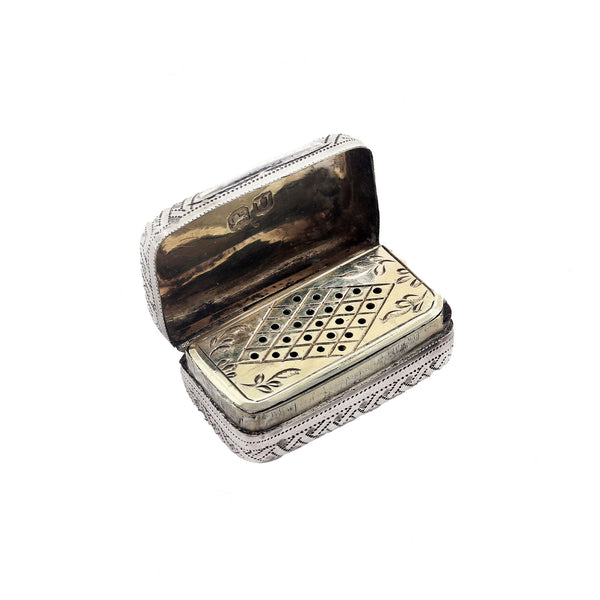 Decorative silver and gold box with intricate patterns on a white background