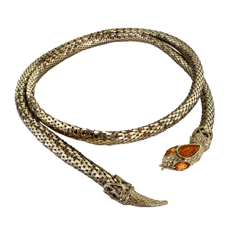 Snake-shaped bracelet with amber tone eyes on a white background