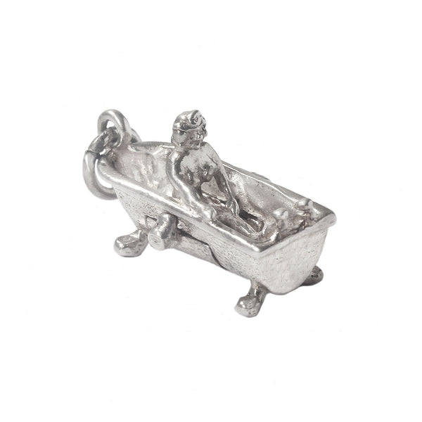 Silver charm of a person in a bathtub on a white background