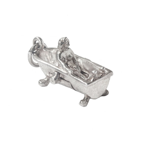 Silver charm of a person in a bathtub on a white background