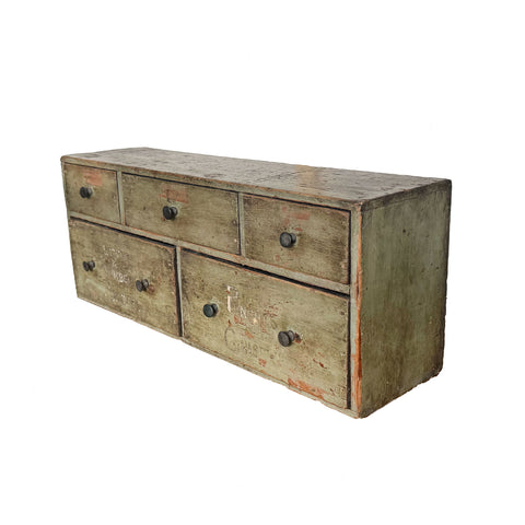 Vintage wooden dresser with multiple drawers on a white background