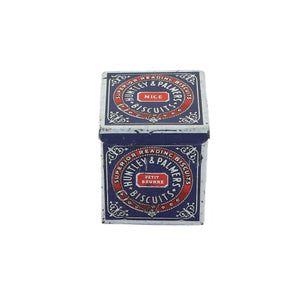 A vintage miniature Huntley & Palmers biscuit tin box with red, blue, and white detailing, featuring the brand's logo.
