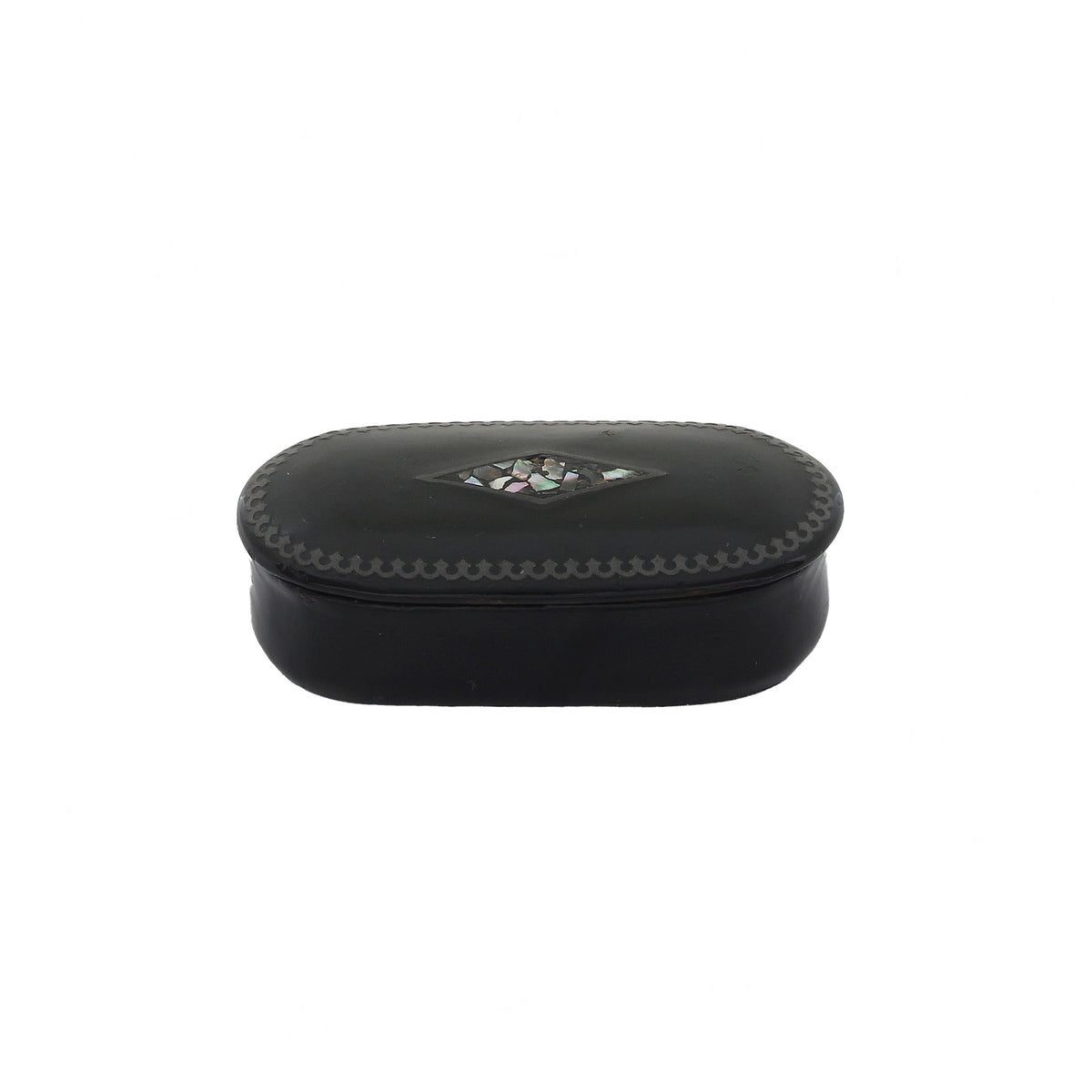 Vintage black papier mache snuff box with mother of pearl detailing on the lid, closed lid showing signs of wear.