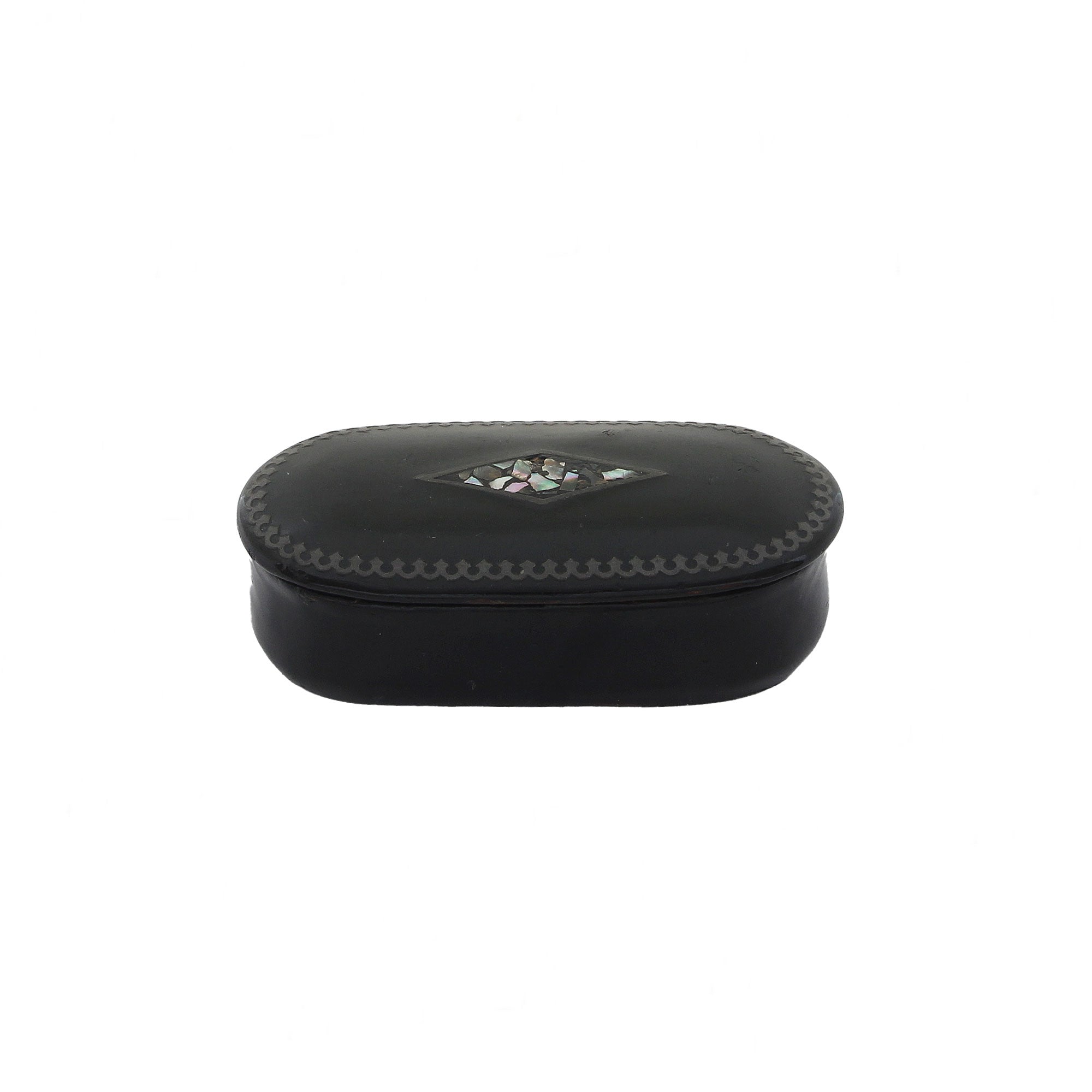 Vintage black papier mache snuff box with mother of pearl detailing on the lid, closed lid showing signs of wear.
