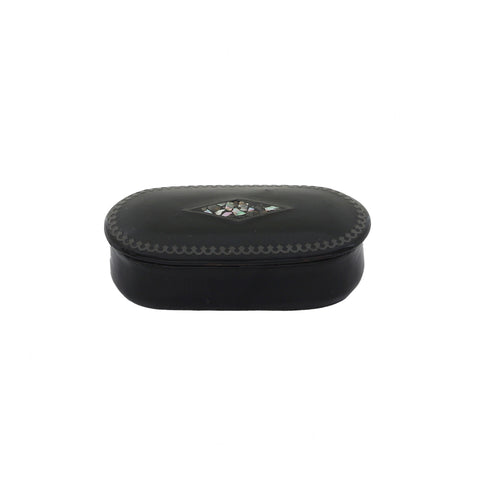Vintage black papier mache snuff box with mother of pearl detailing on the lid, closed lid showing signs of wear.