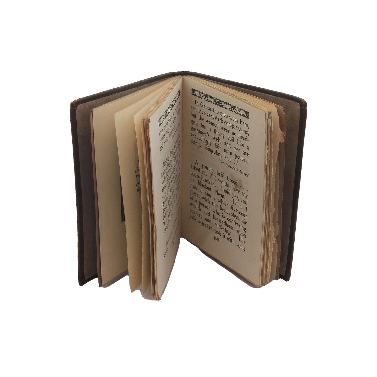 A miniature preowned book by Mark Twain showing inside pages upright