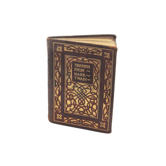 A miniature book with a decorative front cover featuring a Celtic design, labeled 'Thoughts from Mark Twain'.